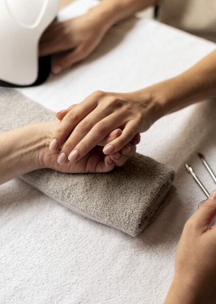 close-up-manicurist-holding-nail-tool-min